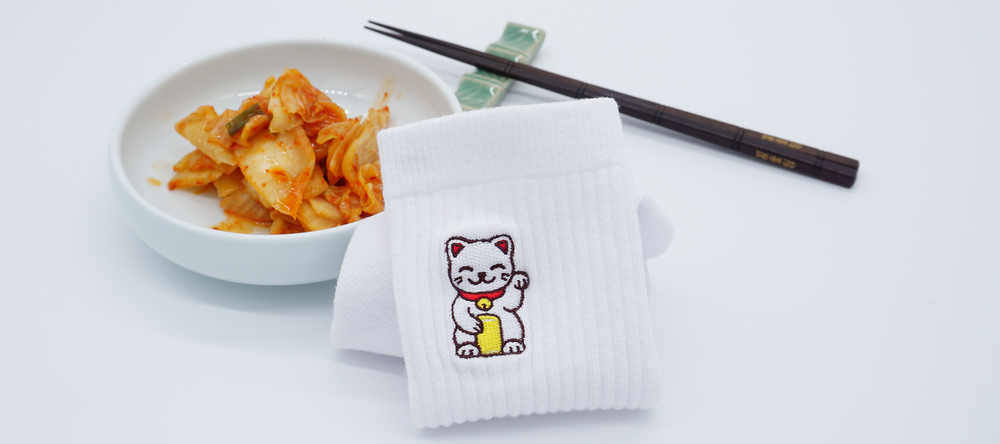 KYU.ONE: Asian cat embroidered on white crew sock with kimchi in the back Banner